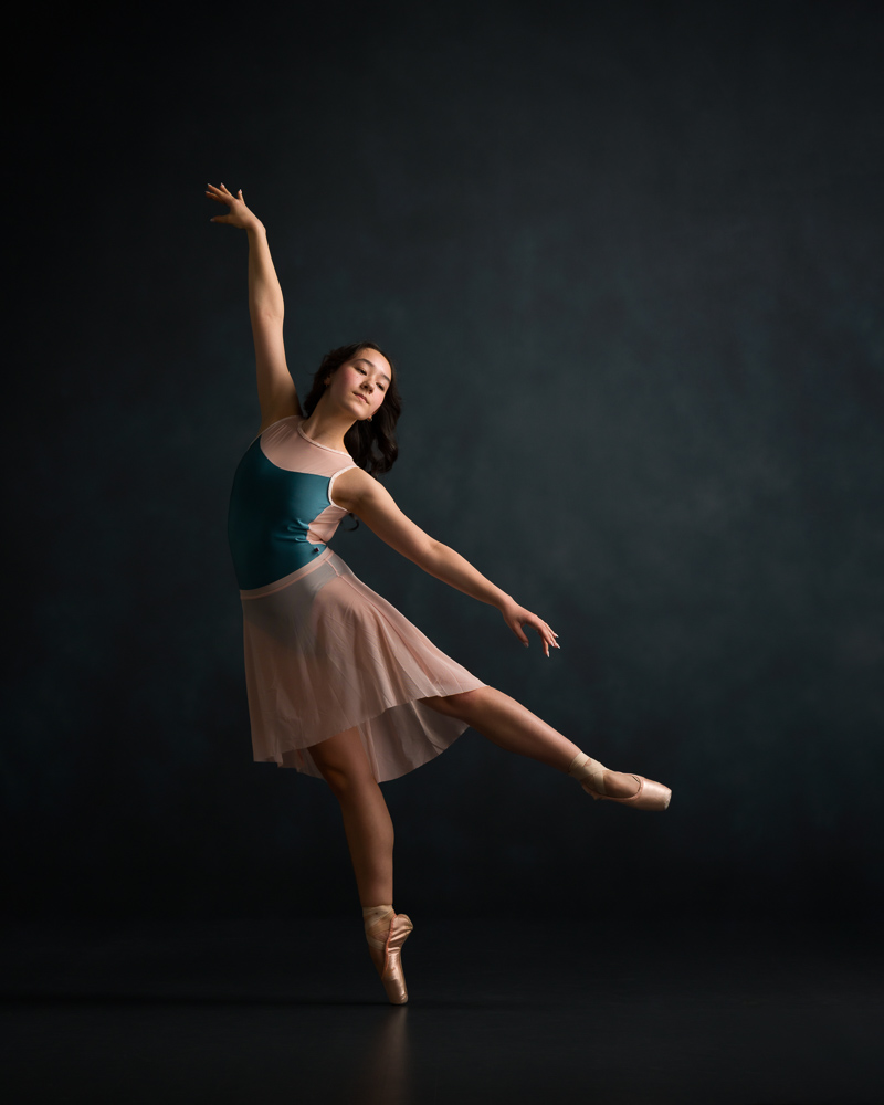 Teen Ballet Dancer in low arabesque with mid-length skirt