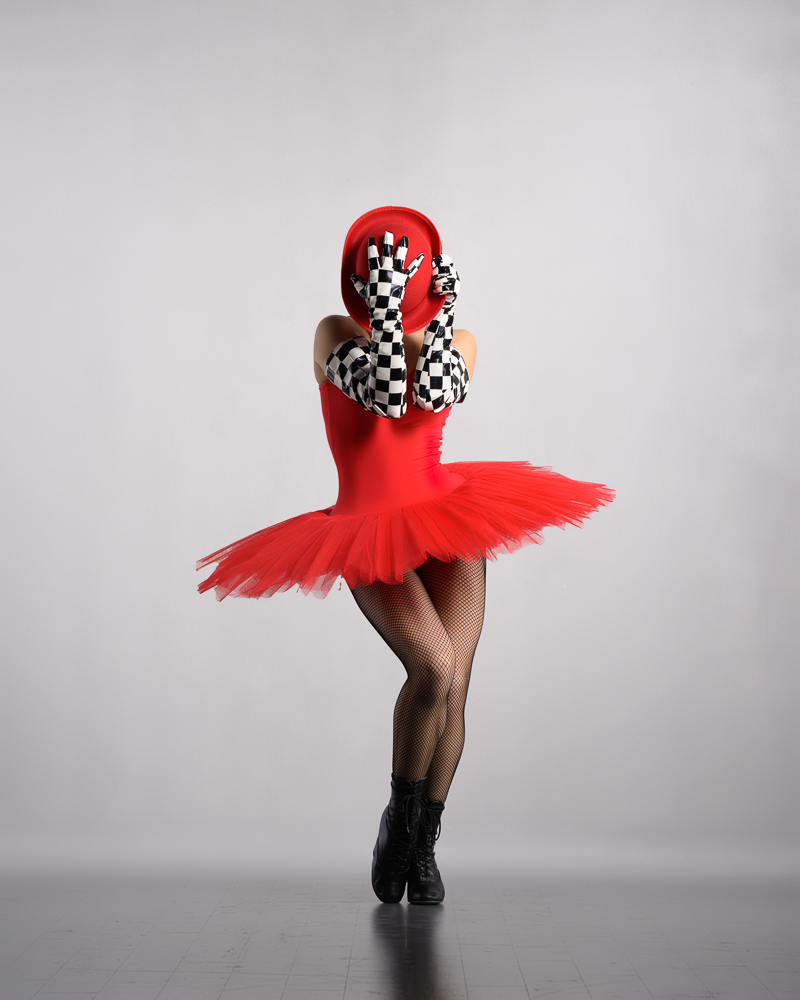 Commerical Dancer in red tutu and Laduca shoes with checkered gloves in classic caberet pose