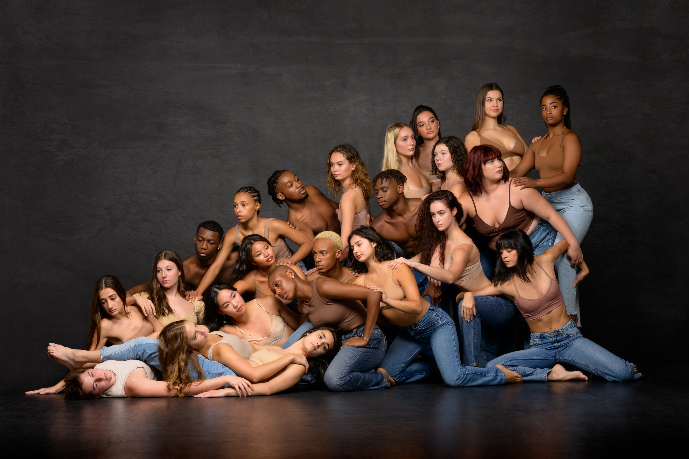 Group photo of dance troupe that looks like an avalanche of bodies