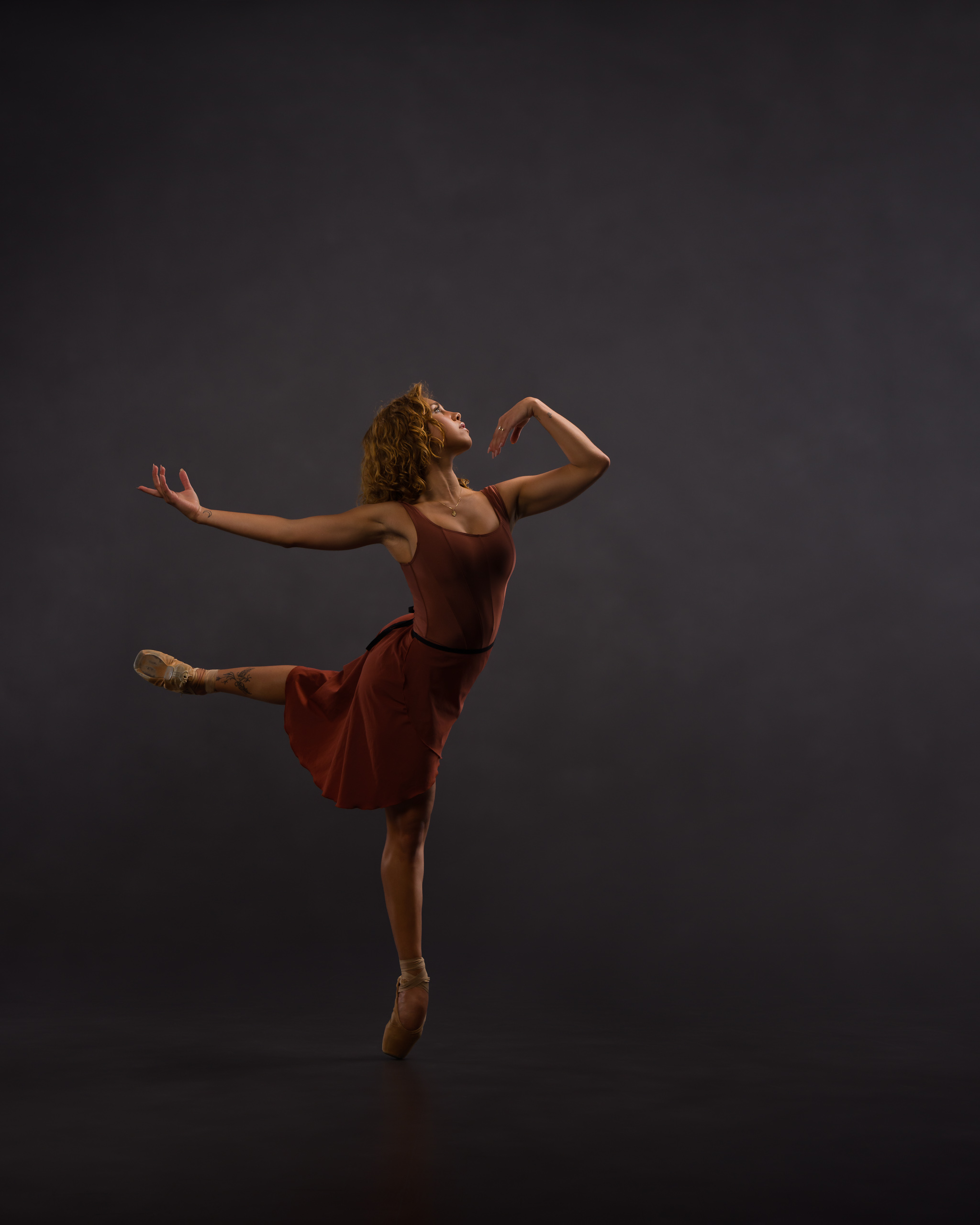 Ballerina in full movement forward in attitude