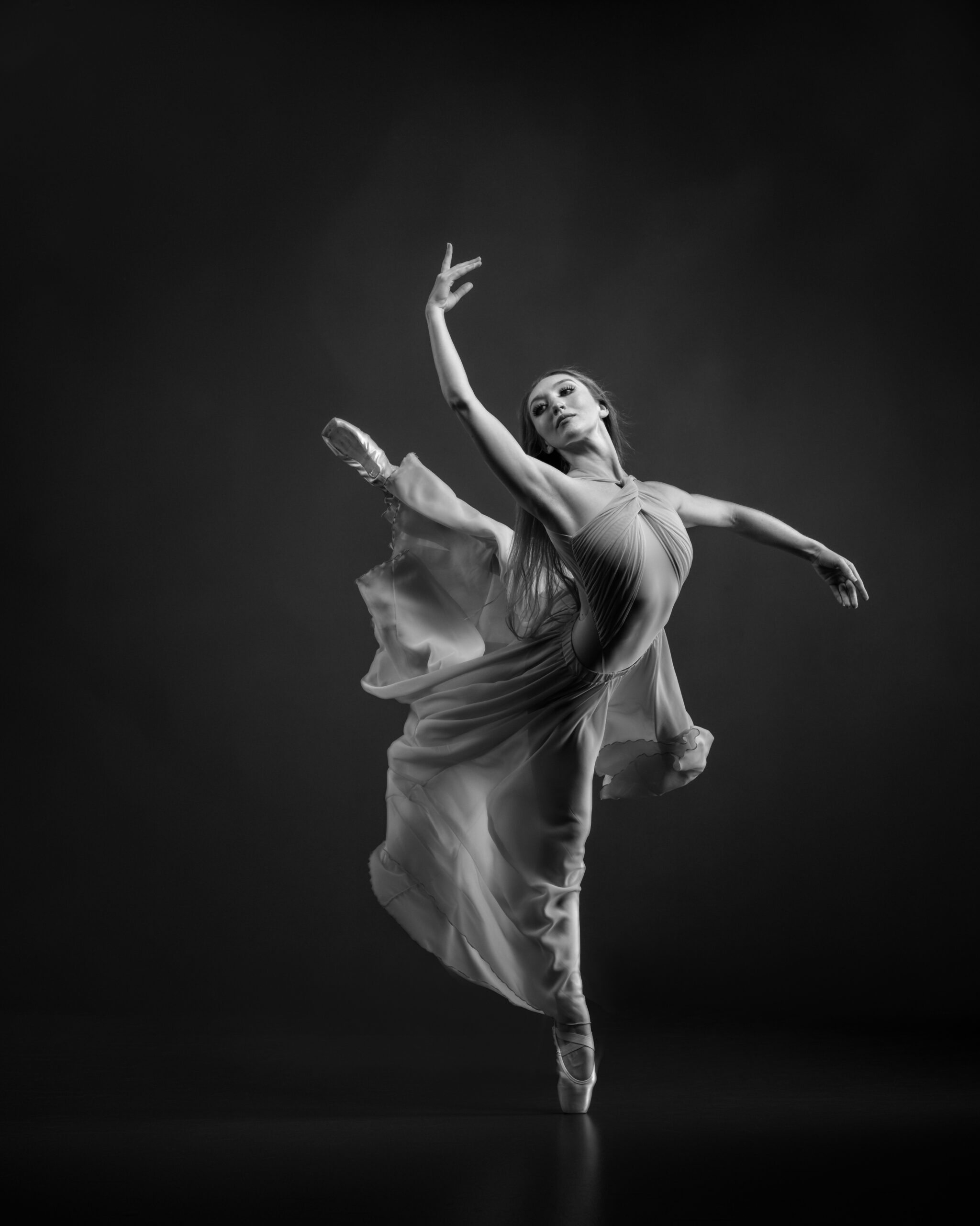 B&W Photo of dancer in attitude in a flowing skirt