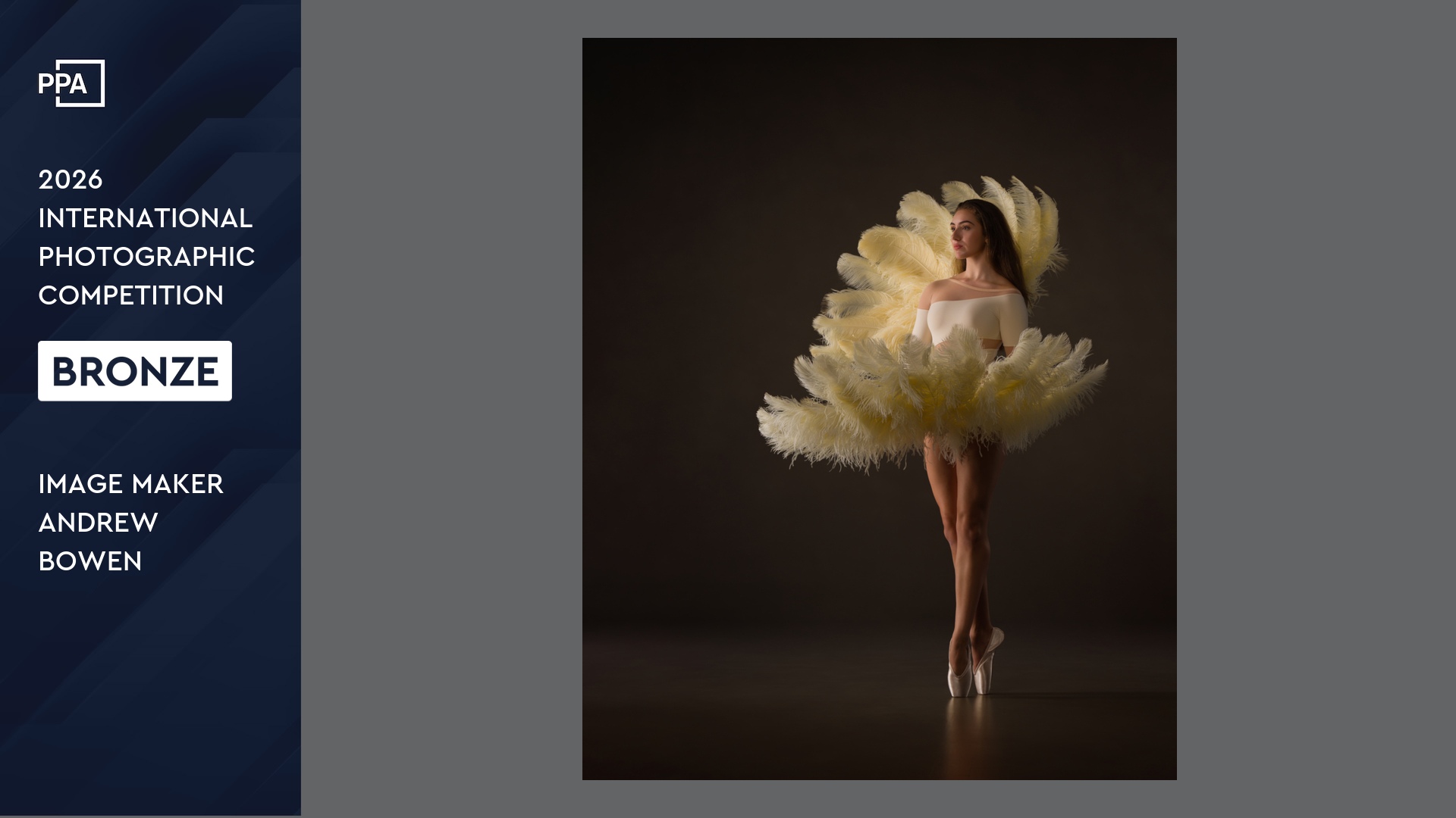 Teen dancer as if emerging from a clamshell formed of feather fans.