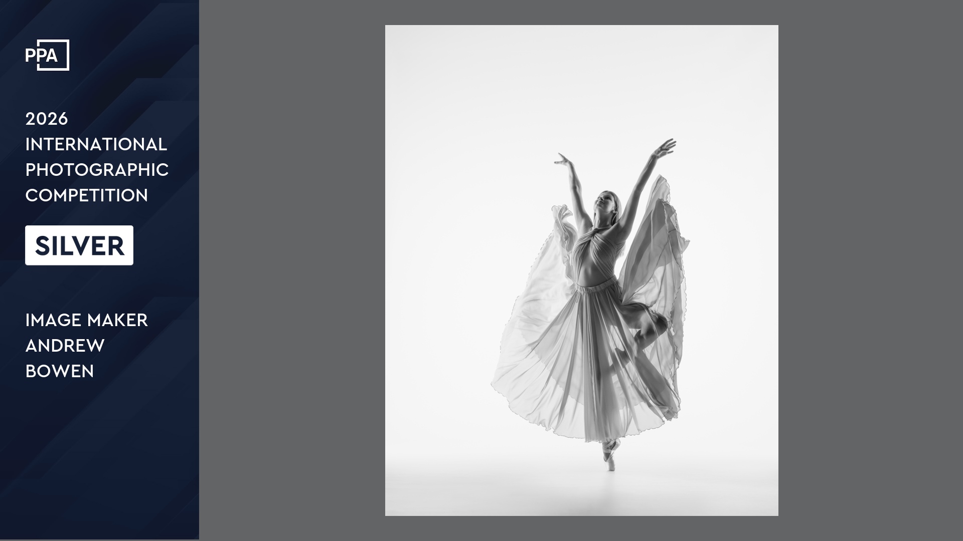 Black and white high key image of HS Senior dance in passe with flowing full skirt and up-stretched arms.
