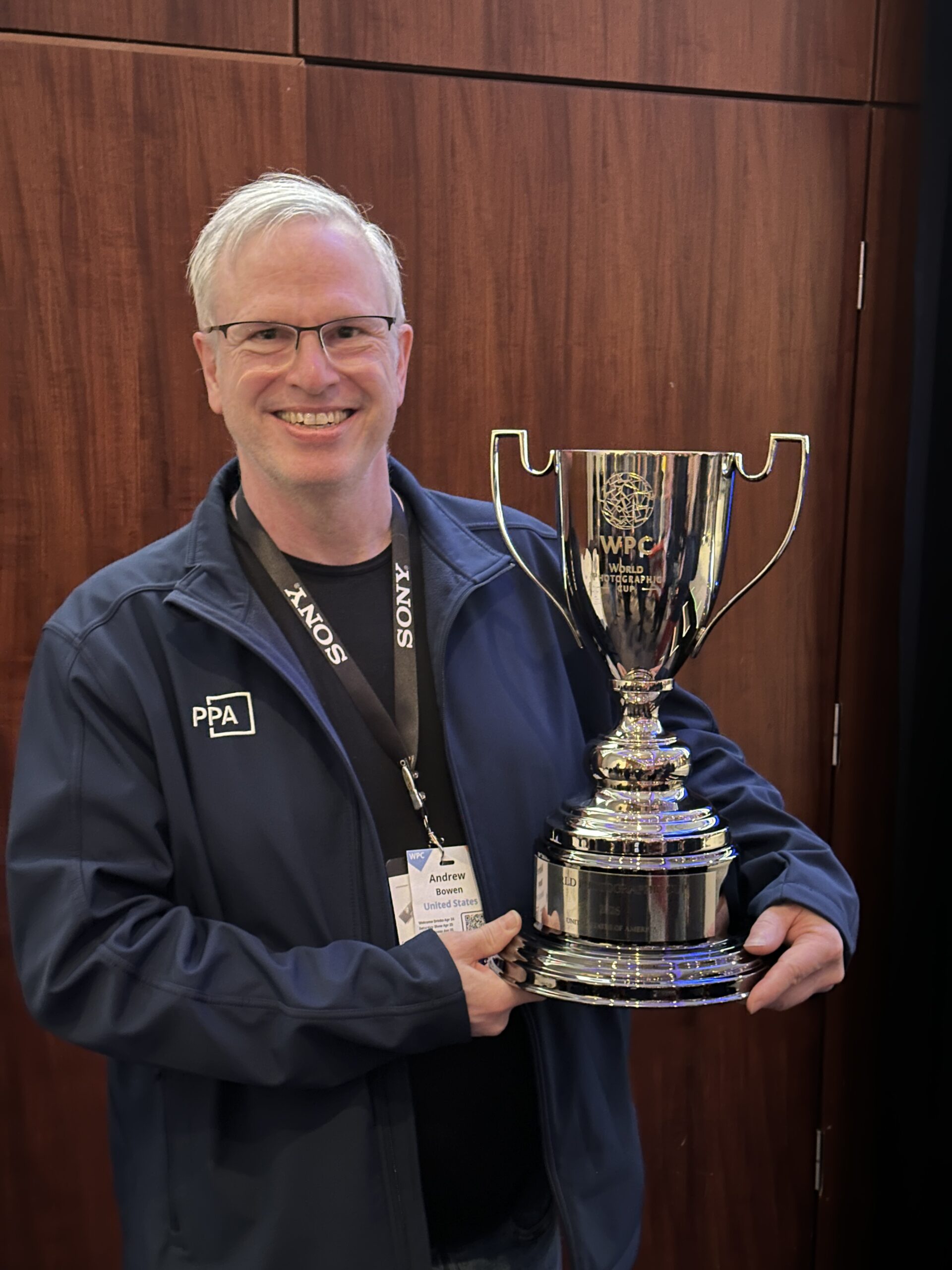 Andrew Bowen holding the 2026 World Photographic Cup (he's happy)